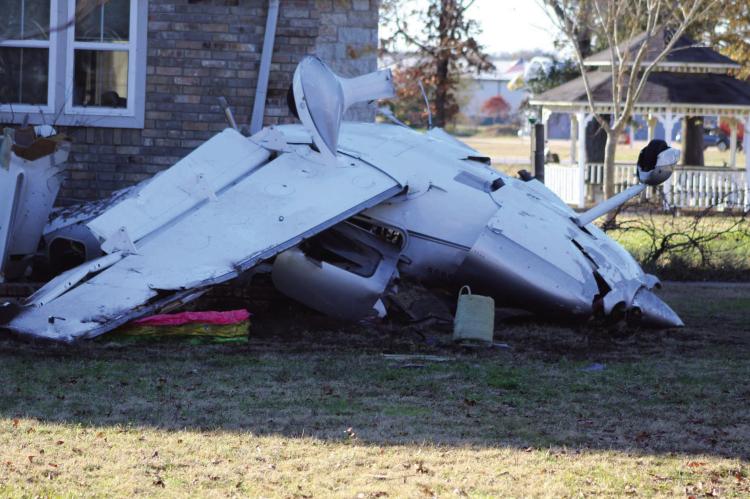 A civilian aircraft crashed in the area of Private Road 7005 in Edgewood on Dec. 26, 2003, at around 6 p.m. The plane came to rest, striking a residence at the location and causing minor damage to the home. Photo by Nick Gibbons, The County Eagle