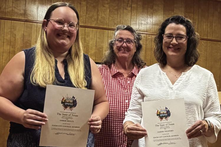 Amber Shults (far left) and Jammie Thedford (far right) were sworn in as members of the Edom City Council July 9 during the regular monthly meeting of the council. Standing with the sworn-in council members was Edom Mayor Barbara Crow. Courtesy photo