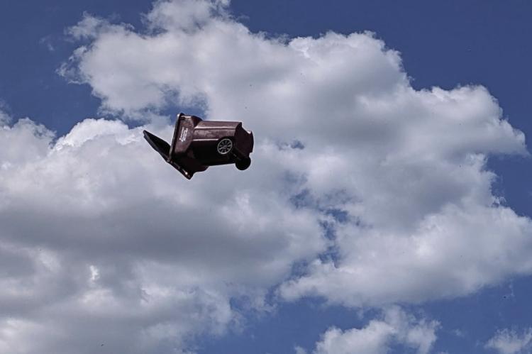 On Monday afternoon a whirlwind or dust devil traveled along West Tyler St. in Canton, lifting trash bins and debris thirty to fifty feet in the air. The sudden burst of rotating air also damaged a building as it peeled off trim from the edge of the roof. Photo from Brian Edwards