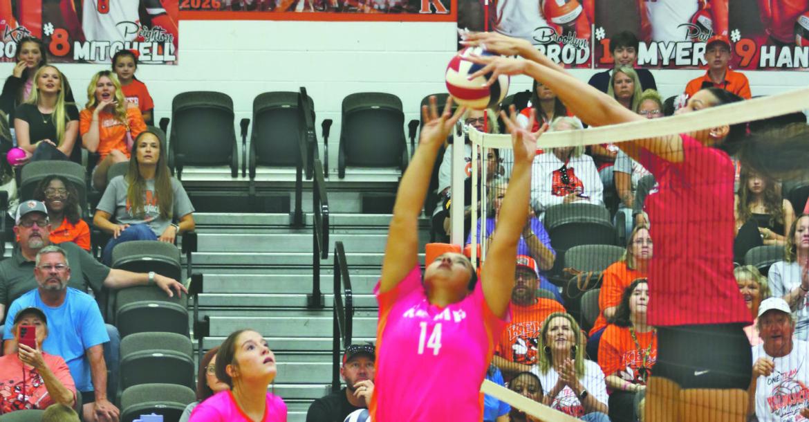 Giana McConico's (#14) set is blocked by Jordan Flodder in Kemp’s home district match versus Van on October 2nd. Photo by Blaine Clamon