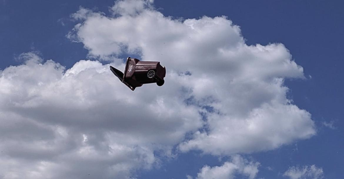 On Monday afternoon a whirlwind or dust devil traveled along West Tyler St. in Canton, lifting trash bins and debris thirty to fifty feet in the air. The sudden burst of rotating air also damaged a building as it peeled off trim from the edge of the roof. Photo from Brian Edwards